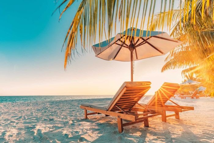 Cảnh biển mùa hè với bãi cát vàng và nước xanh mát, lý tưởng cho kỳ nghỉ dưỡng