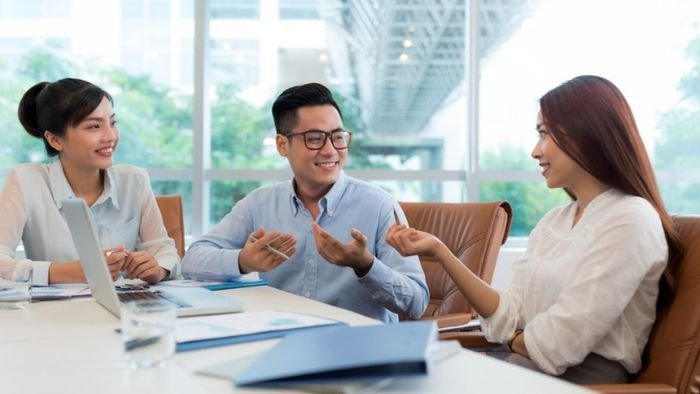 Một người đàn ông bắt tay một người phụ nữ với vẻ mặt biết ơn sâu sắc