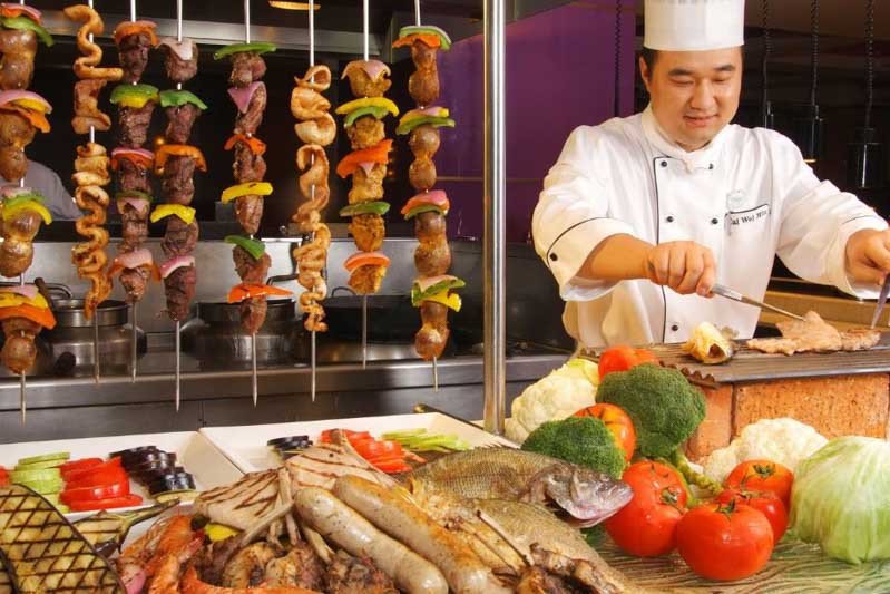 Người phục vụ chúc khách hàng "Enjoy your meal" tại nhà hàng, minh họa giao tiếp lịch sự bằng từ vựng tiếng Anh trong nhà hàng.