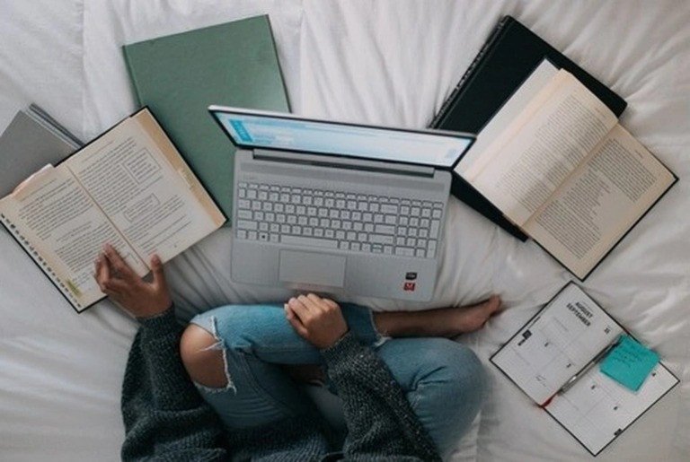 Một sinh viên đang nhìn chằm chằm vào màn hình máy tính với vẻ mặt uể oải, phản ánh thiếu động lực học tập